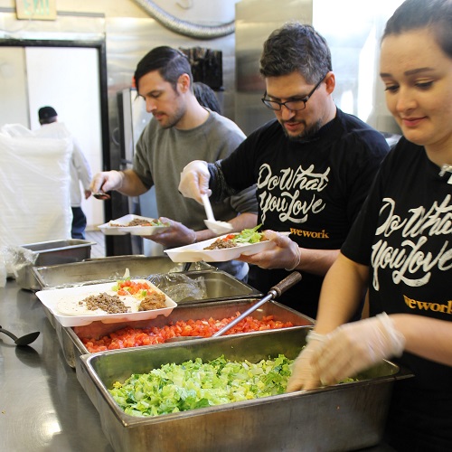 Volunteers serving in a food kitchen